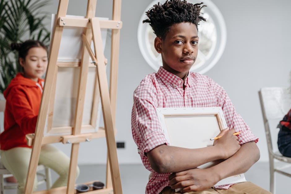 Young students engage in a creative art class, painting on canvases indoors.